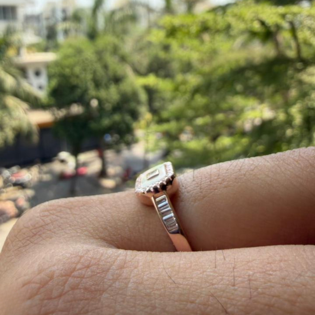 Geometric diamond ring featuring a luminous elongated mother-of-pearl center.