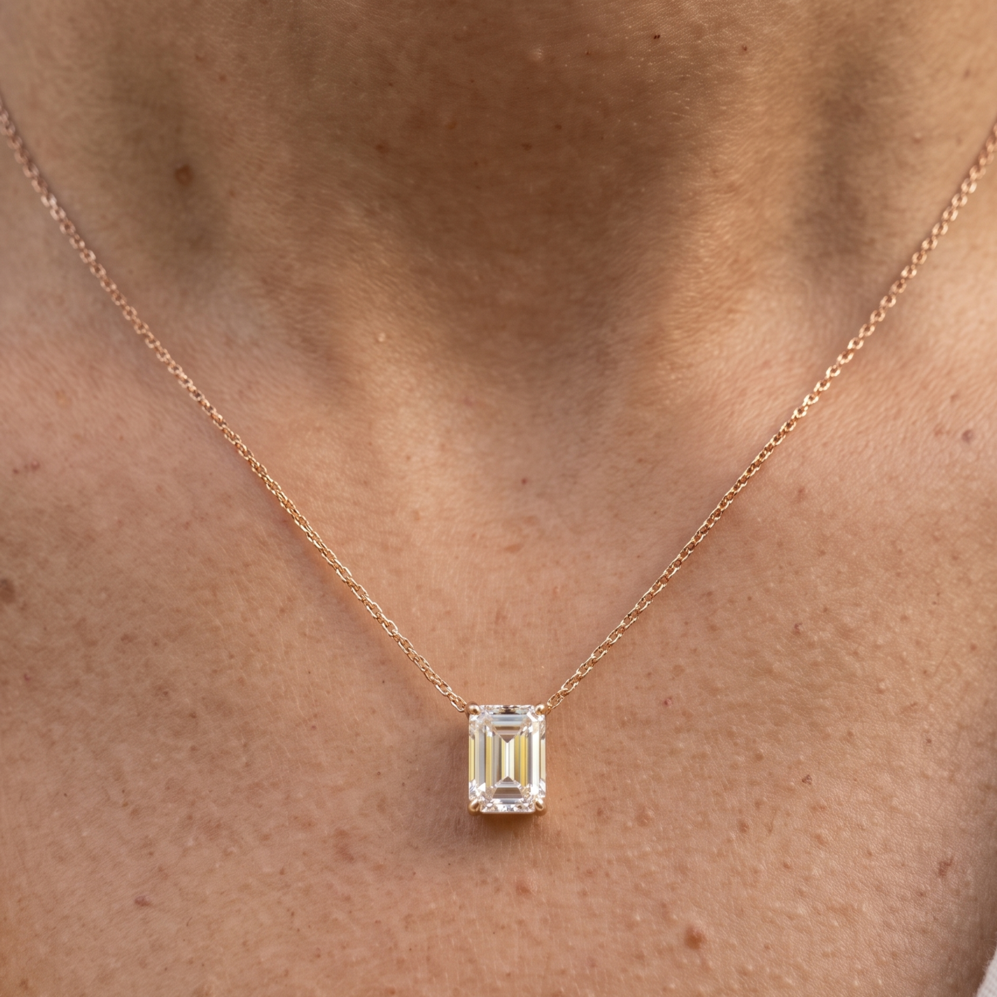 2.58 CT emerald-cut diamond solitaire pendant necklace in polished yellow gold.