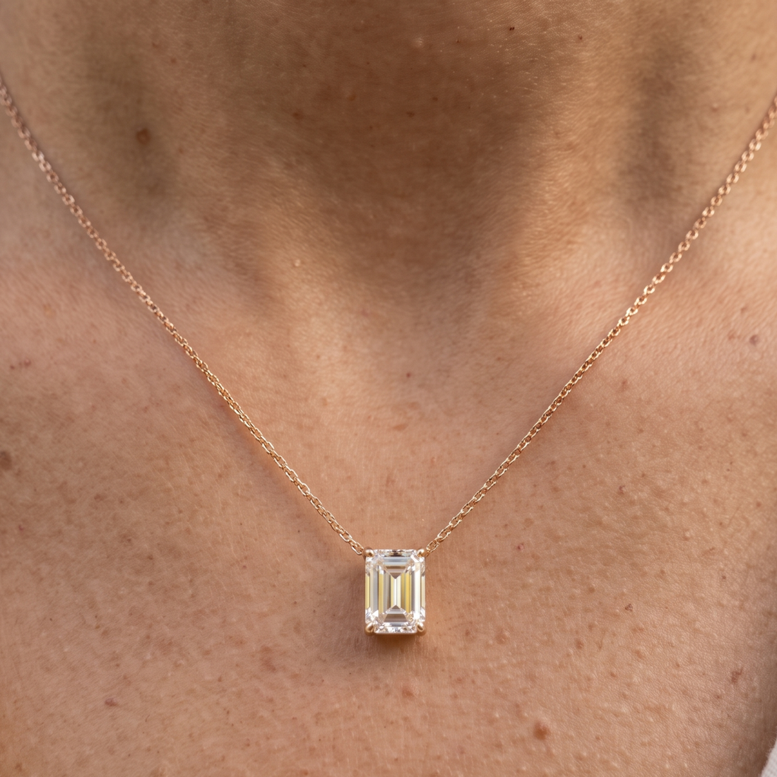 2.58 CT emerald-cut diamond solitaire pendant necklace in polished yellow gold.