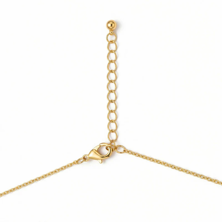 Gold chain necklace with a heart clasp on a white background