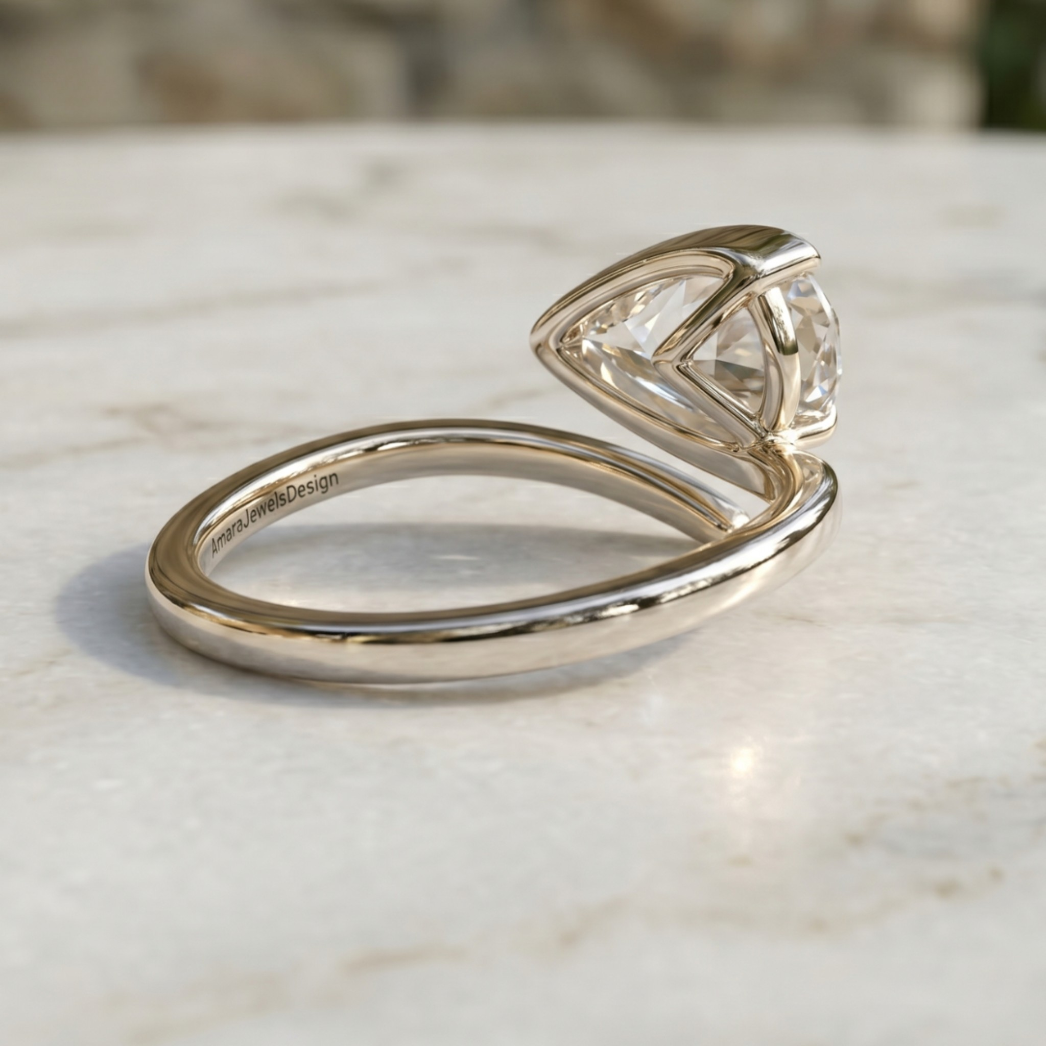 A silver-toned split ring featuring a triangular prong setting with a clear gemstone, resting on a light marble surface.