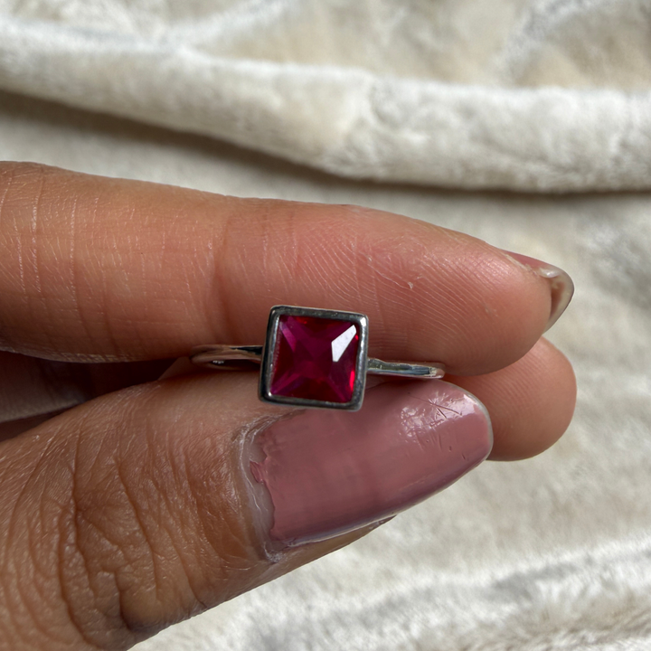 Red princess-cut gemstone solitaire ring in white gold by Kiashaa Jewellery.