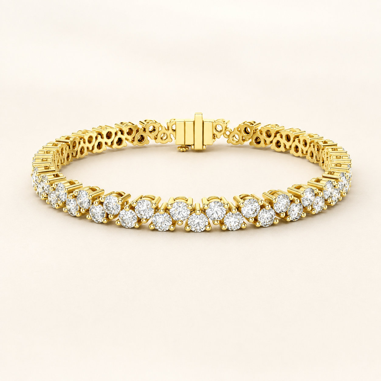 A yellow gold tennis bracelet featuring rows of round-cut clear gemstones in a classic three-stone cluster setting, displayed on a clean, light beige background.