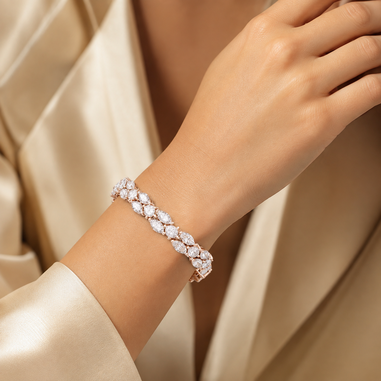 A close-up of a woman's wrist wearing a sparkling diamond tennis bracelet in rose gold, styled with a cream satin robe.