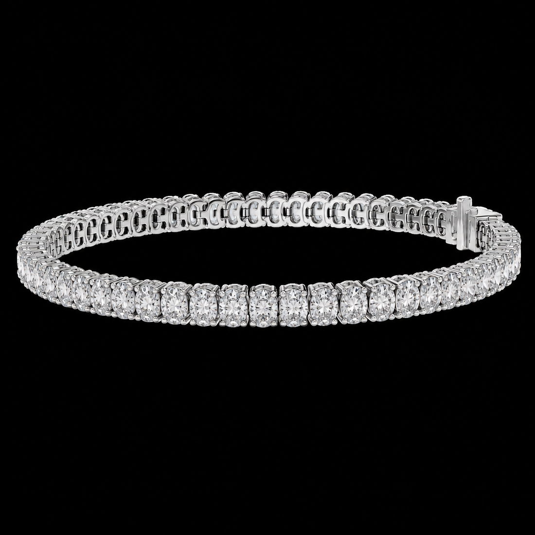 A diamond tennis bracelet in a silver-toned metal setting, displayed against a solid black background.