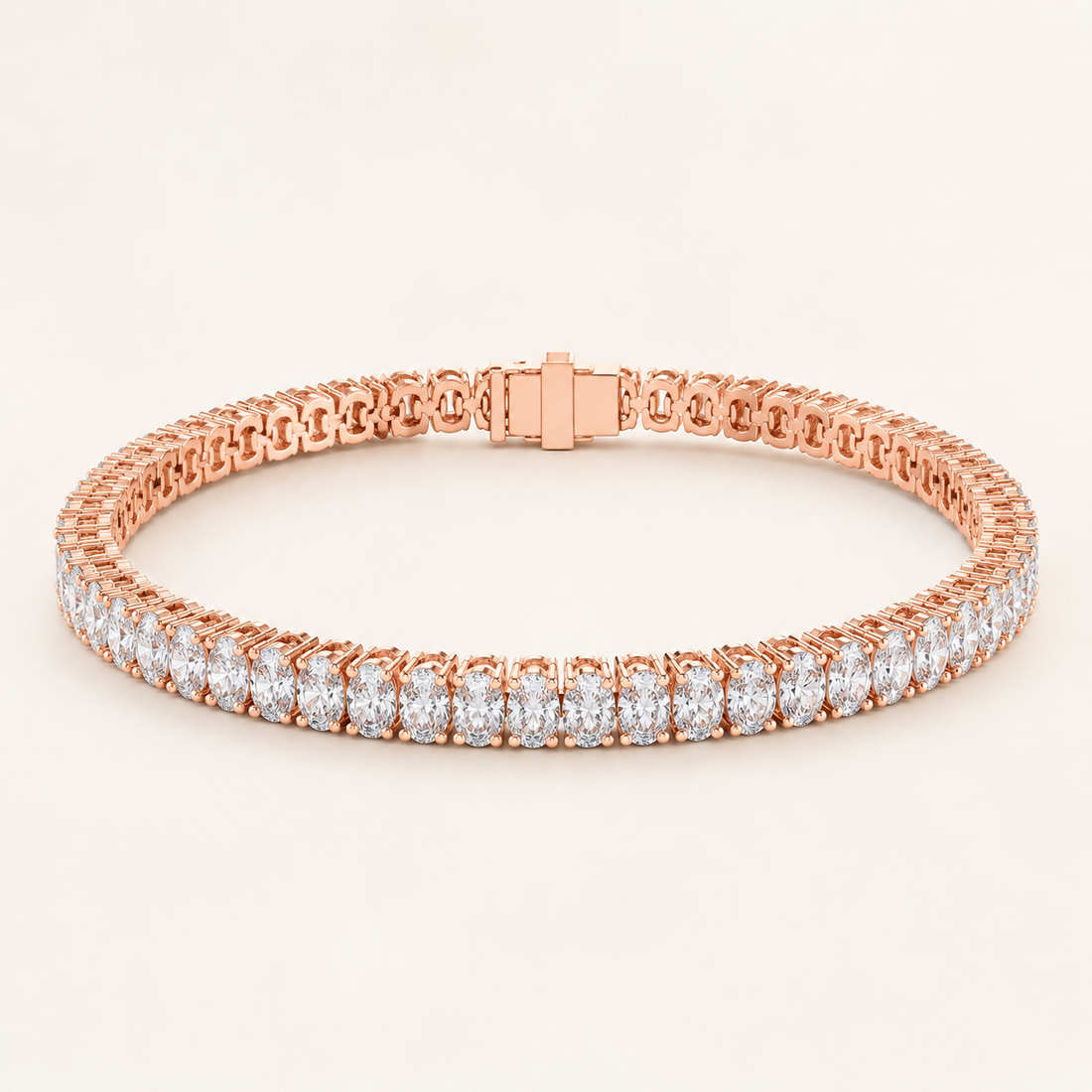 A rose gold tennis bracelet with a continuous row of round-cut clear gemstones, displayed on a clean, light beige background.
