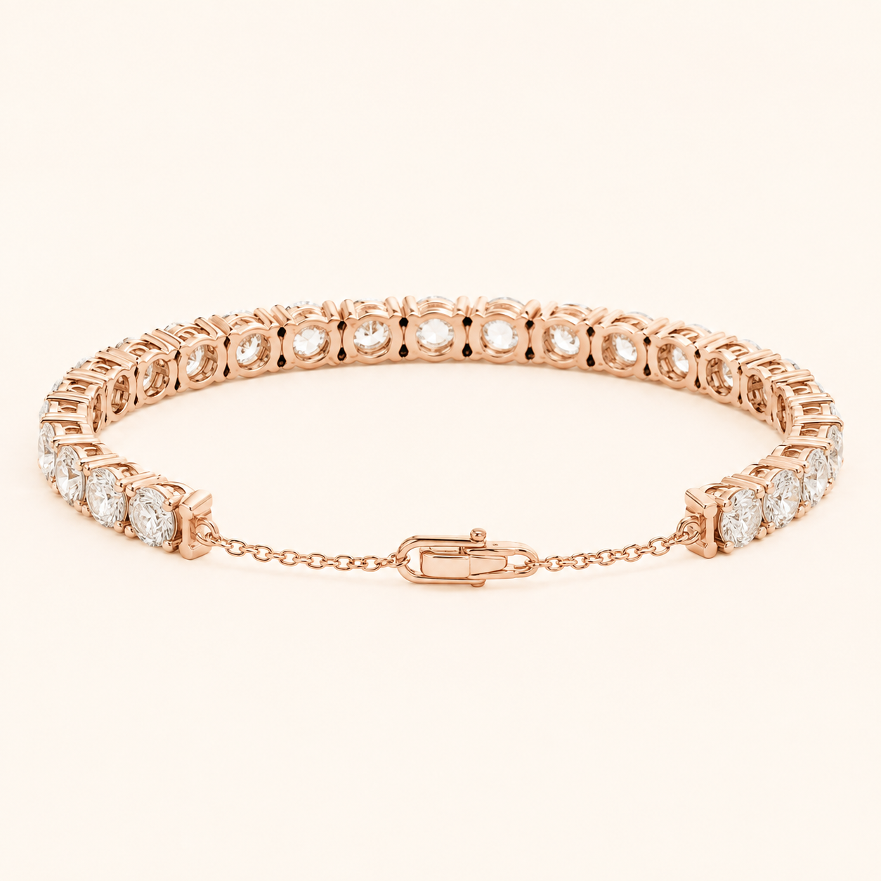 A rose gold tennis bracelet with round-cut clear gemstones, displayed on a clean, light beige background.