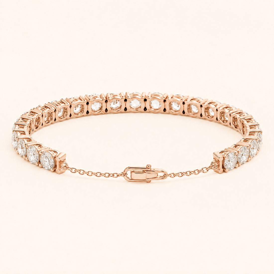 A rose gold tennis bracelet with round-cut clear gemstones, displayed on a clean, light beige background.