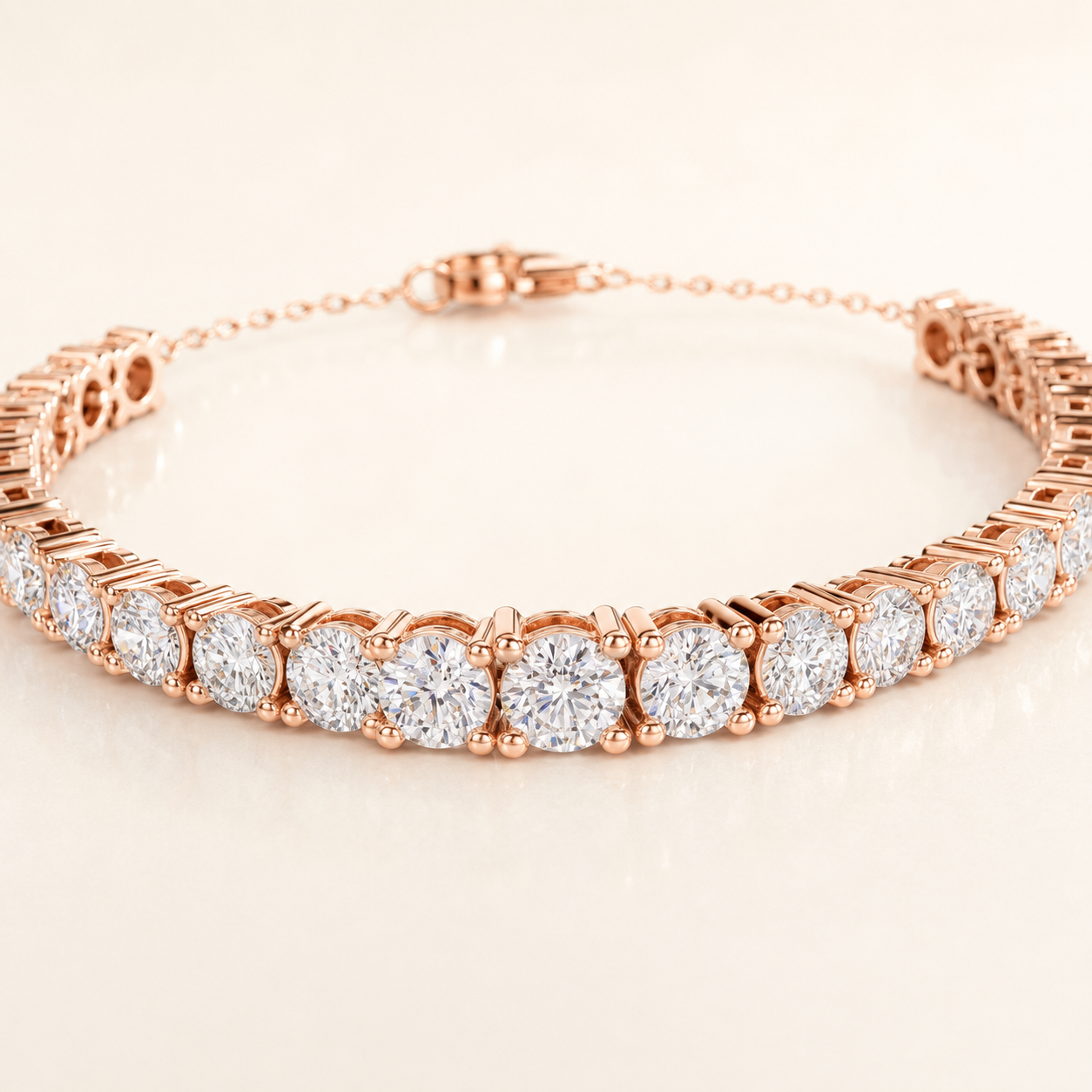 A rose gold tennis bracelet featuring a row of round brilliant-cut diamonds in a prong setting, displayed on a clean, light beige reflective surface.