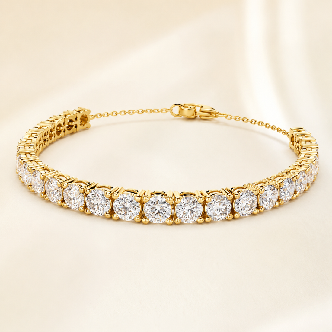 A yellow gold tennis bracelet featuring round brilliant-cut diamonds in a classic solitaire setting, displayed on a soft beige satin background.