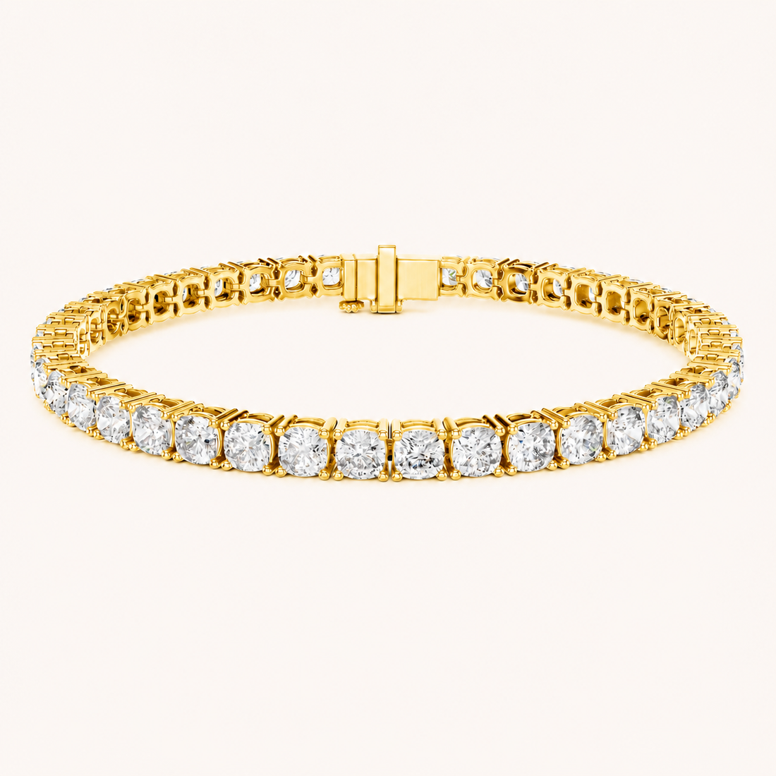 A yellow gold tennis bracelet featuring a continuous row of round-cut clear gemstones in a prong setting, shown against a plain off-white background.