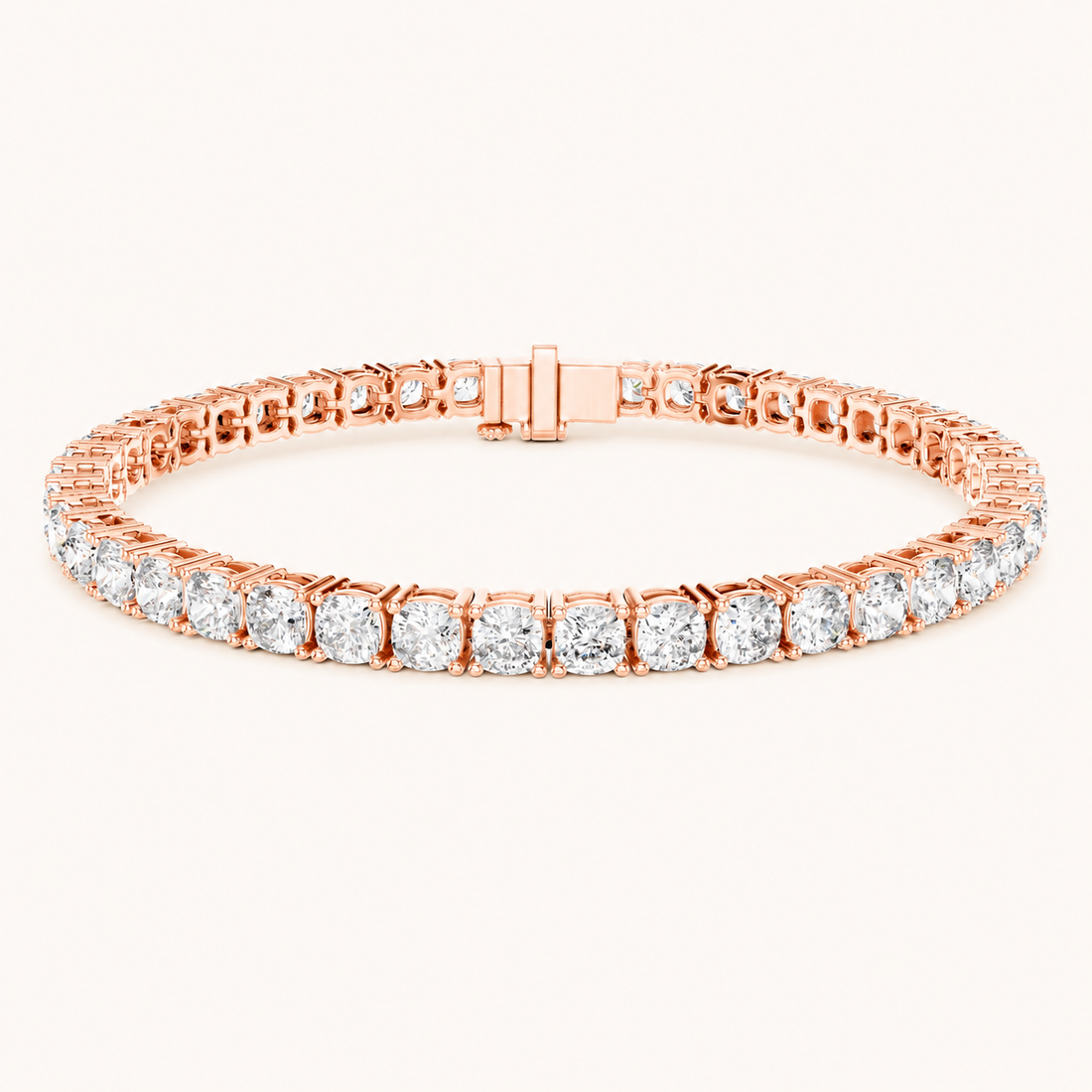 A rose gold tennis bracelet featuring a continuous row of round-cut clear gemstones in a prong setting, displayed on a clean off-white background.