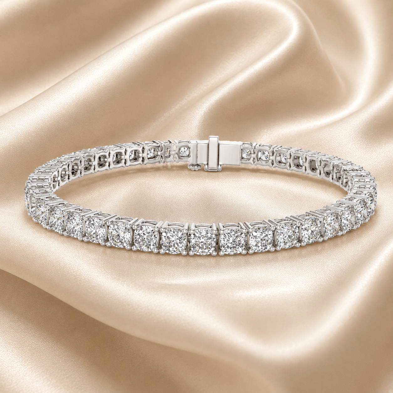 A silver tennis bracelet set with sparkling clear stones, displayed on a draped beige satin fabric background.