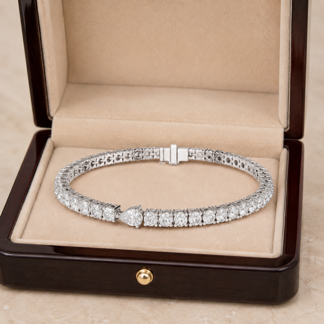 A diamond tennis bracelet displayed inside an open dark wood jewelry box with a beige velvet lining.
