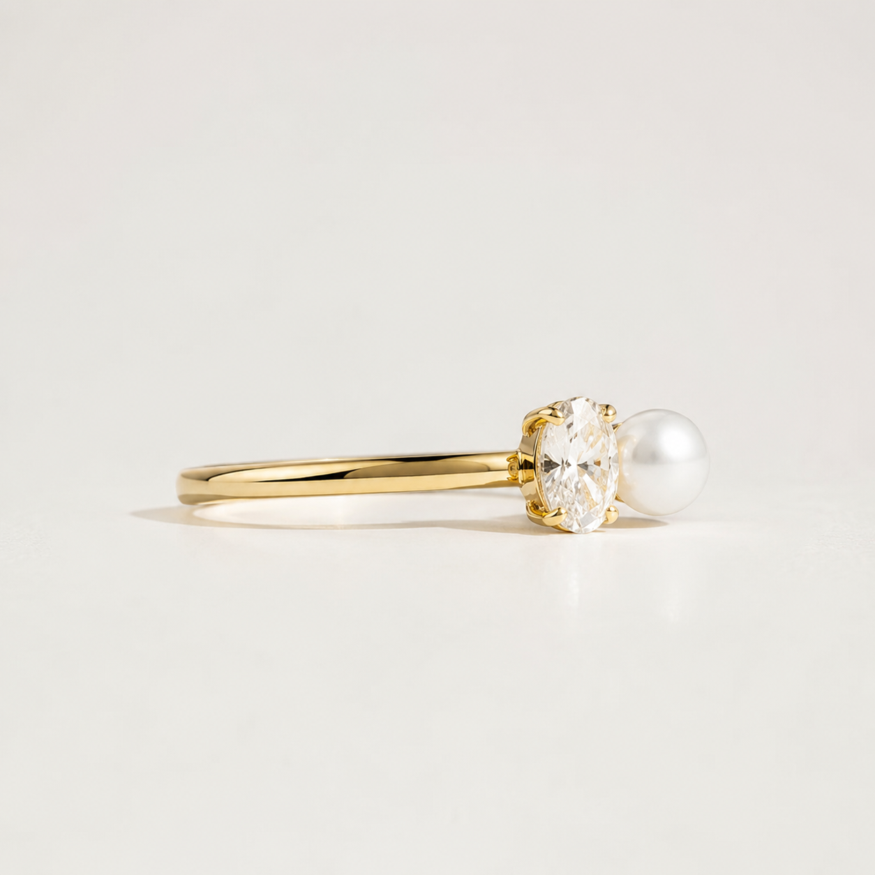 Luxury oval lab-grown diamond and pearl ring in yellow gold by Kiashaa Jewellery with a smooth slender band