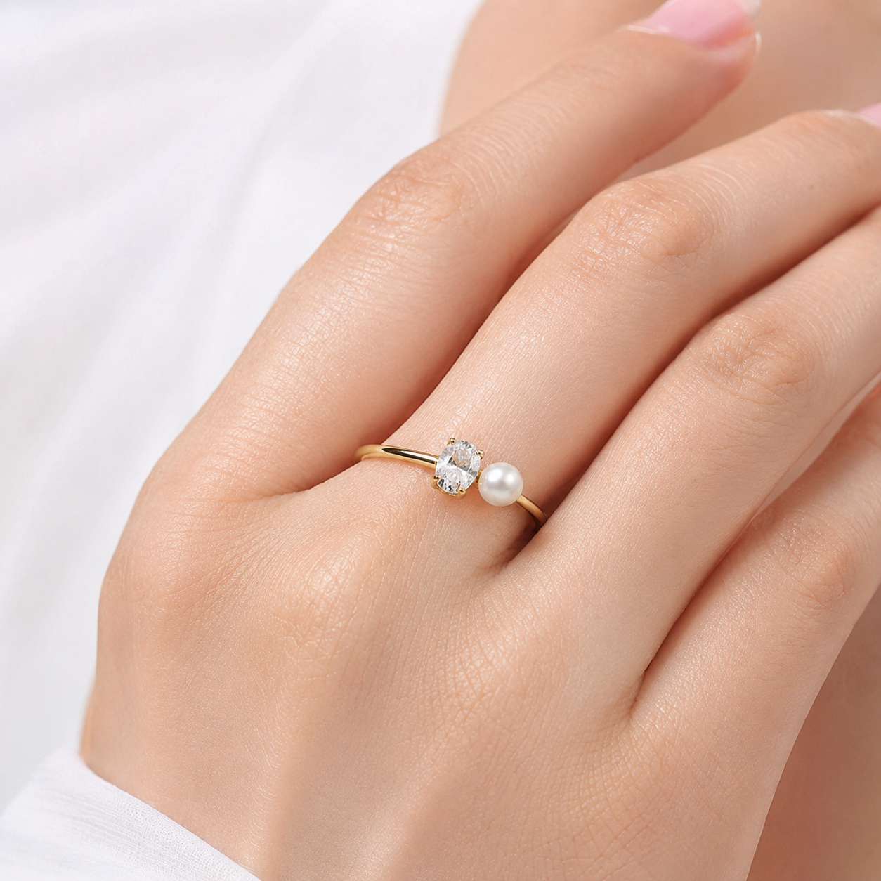 Close-up of Kiashaa Jewellery oval lab-grown diamond and pearl ring in yellow gold with a four-prong setting
