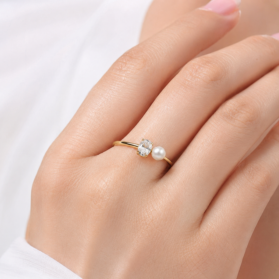 Close-up of Kiashaa Jewellery oval lab-grown diamond and pearl ring in yellow gold with a four-prong setting