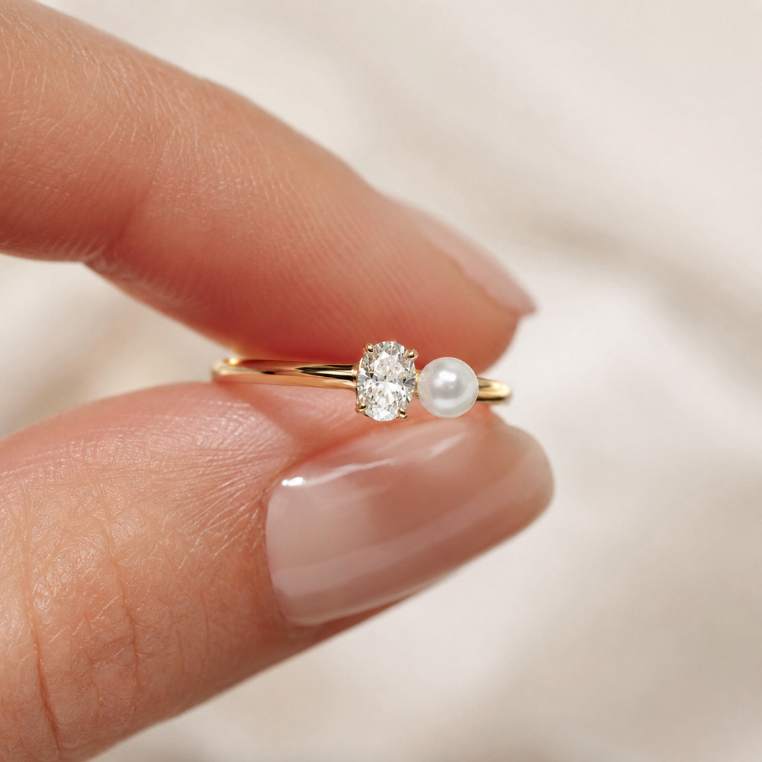 Modern oval lab-grown diamond and pearl ring in polished yellow gold from Kiashaa Jewellery, viewed from the front