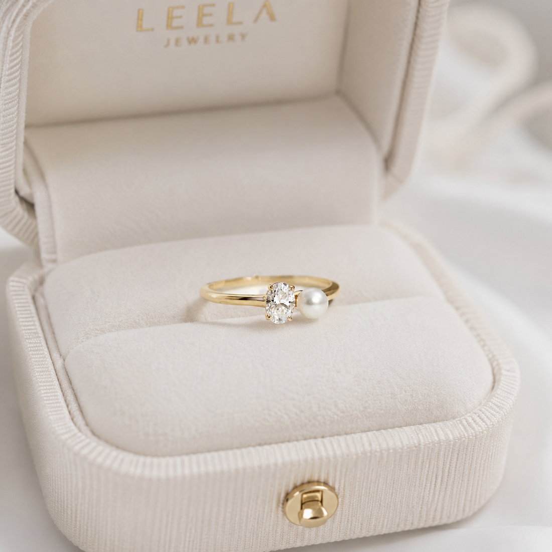 Kiashaa Jewellery yellow gold oval lab-grown diamond and pearl ring with an elegant asymmetrical two-stone setting