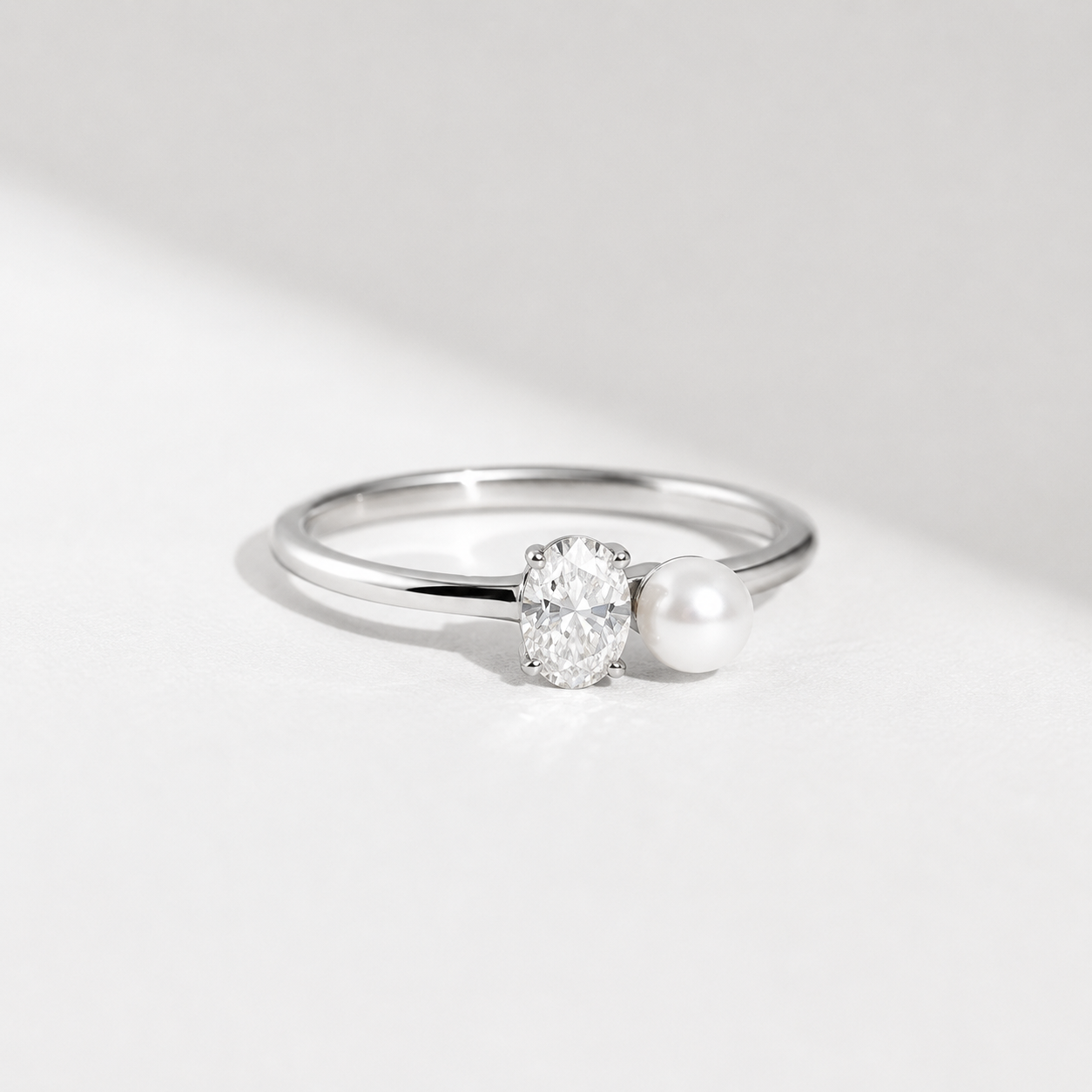 0.5 CT oval lab-grown diamond and pearl ring in yellow gold by Kiashaa Jewellery with a sleek two-stone design