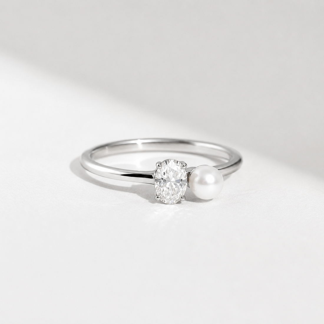 0.5 CT oval lab-grown diamond and pearl ring in yellow gold by Kiashaa Jewellery with a sleek two-stone design