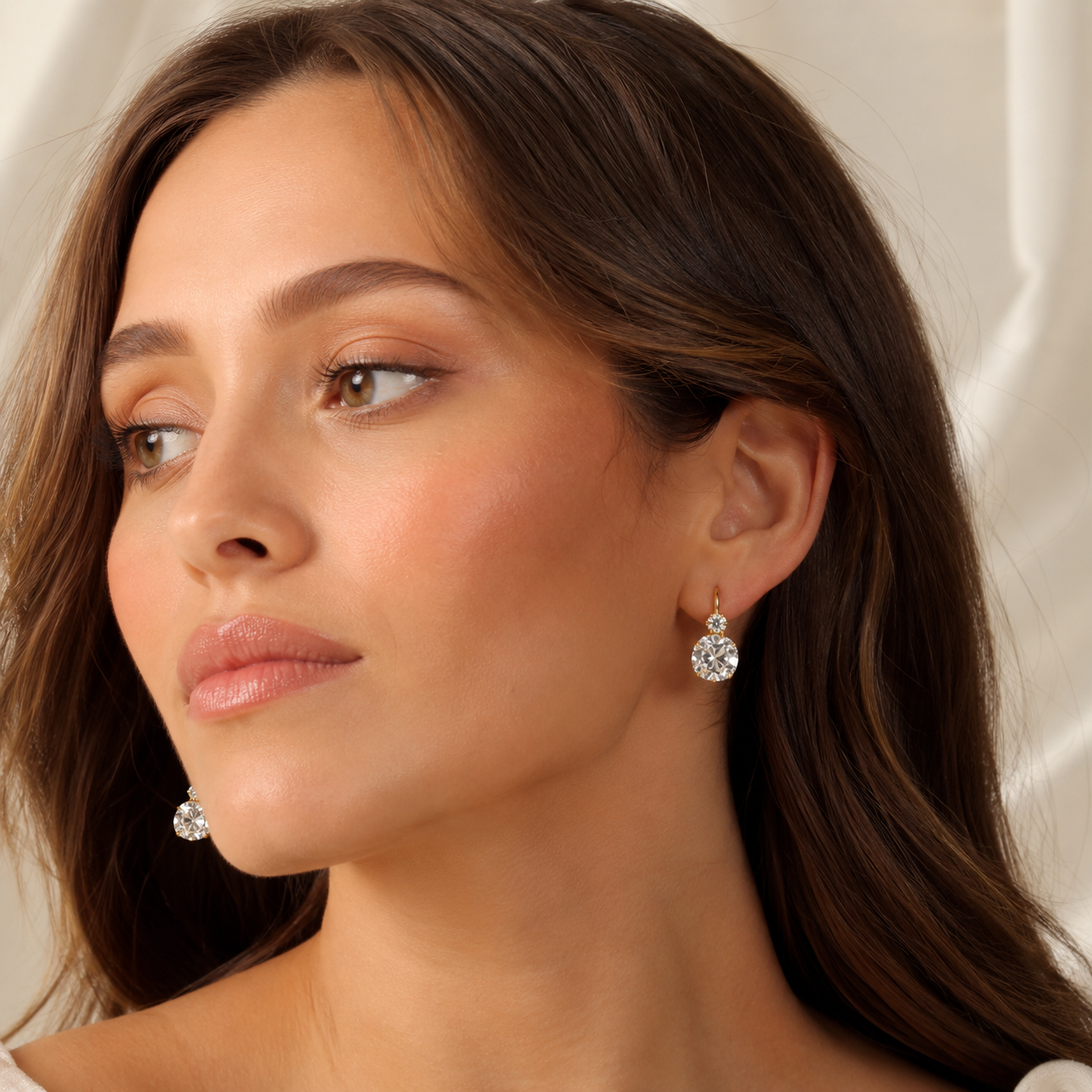 Close-up of Kiashaa Jewellery lab-grown diamond drop earrings with cushion stones in polished yellow gold