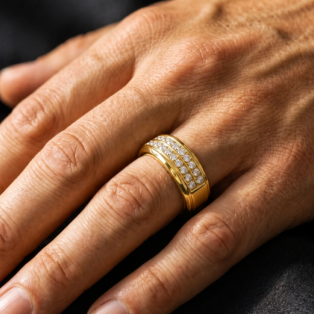 A close-up of a hand wearing a yellow gold ring with pavé-set clear stones. Per the instructions, clear gemstones do not contribute to the color, so the product color is determined solely by the gold metal setting.