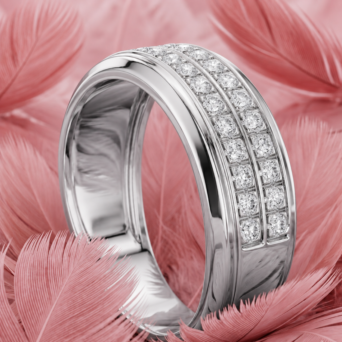 A polished silver-tone ring with two rows of clear pavé stones, displayed on a bed of soft pink feathers.