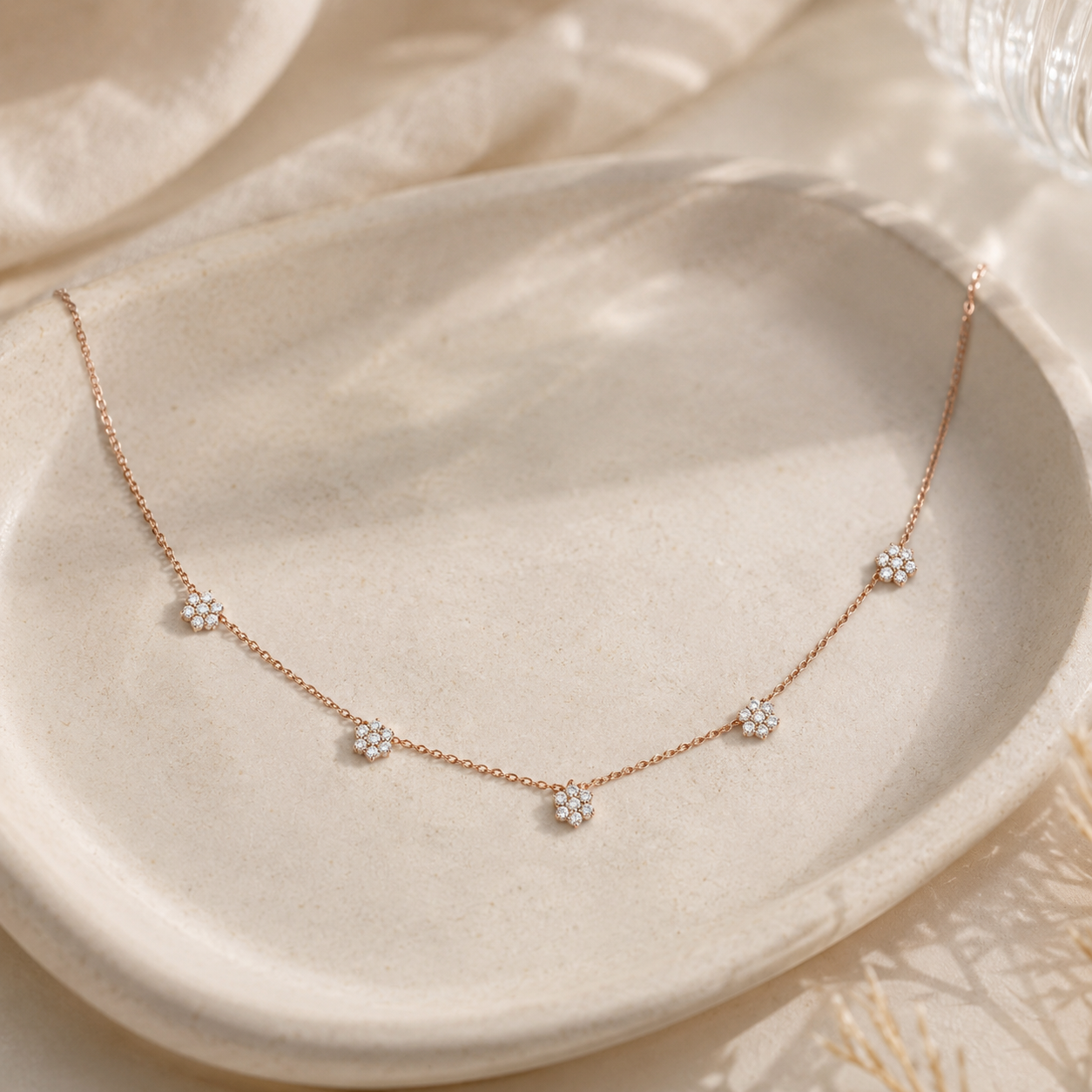 Elegant 1 CT diamond floral station necklace in rose gold by Kiashaa Jewellery on a minimal luxury display