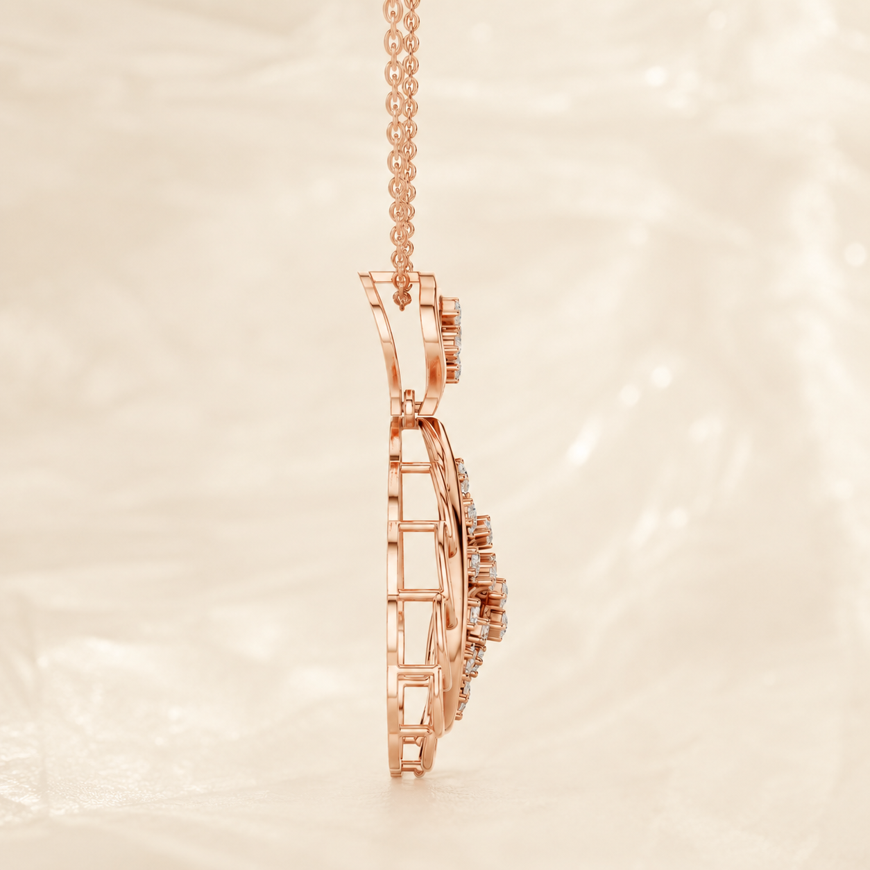 Rose gold pendant necklace with a geometric openwork design and small clear stones, shown hanging against a soft cream background.