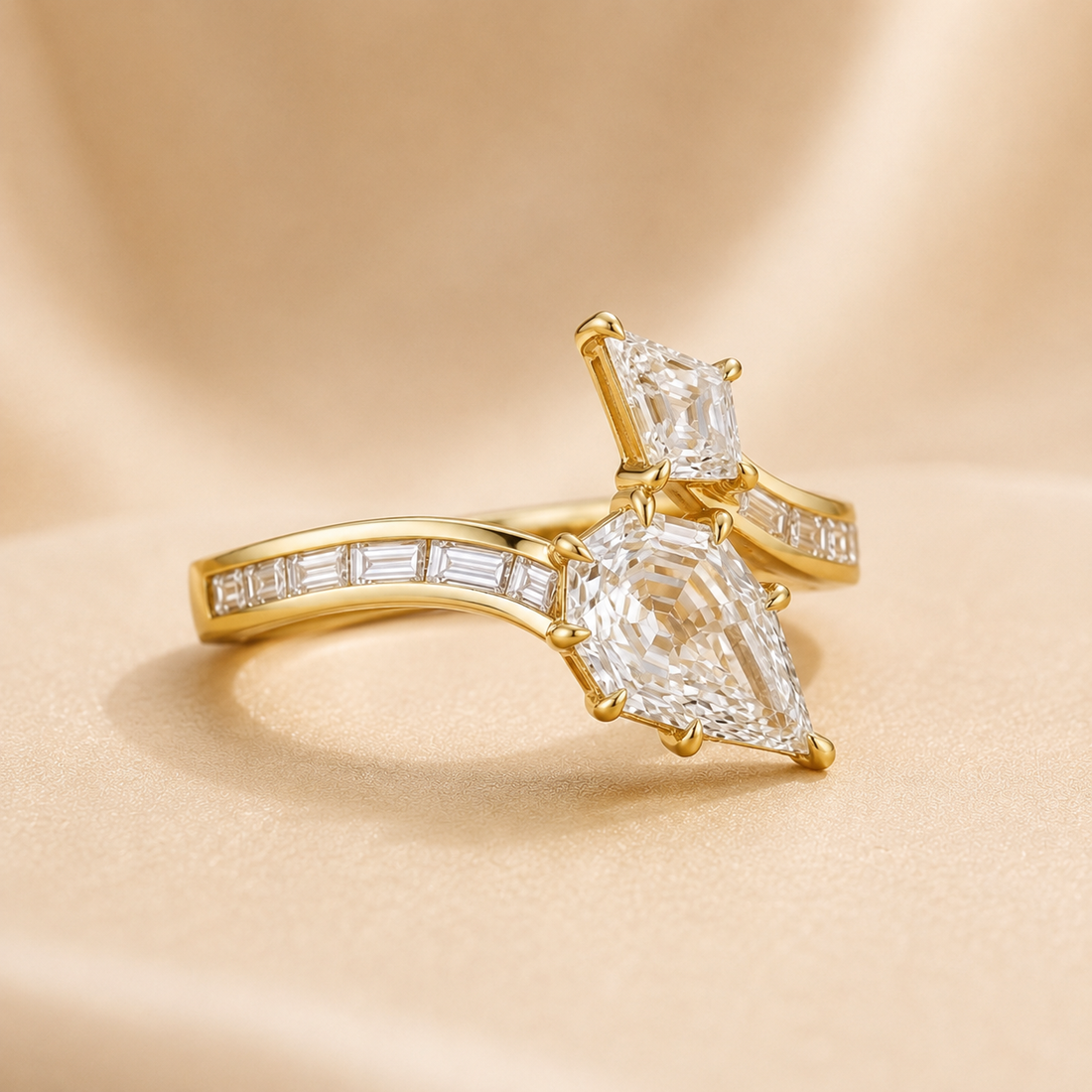 A gold ring with a pear-cut clear center stone and smaller baguette stones along the band, photographed on a soft beige satin-like background.