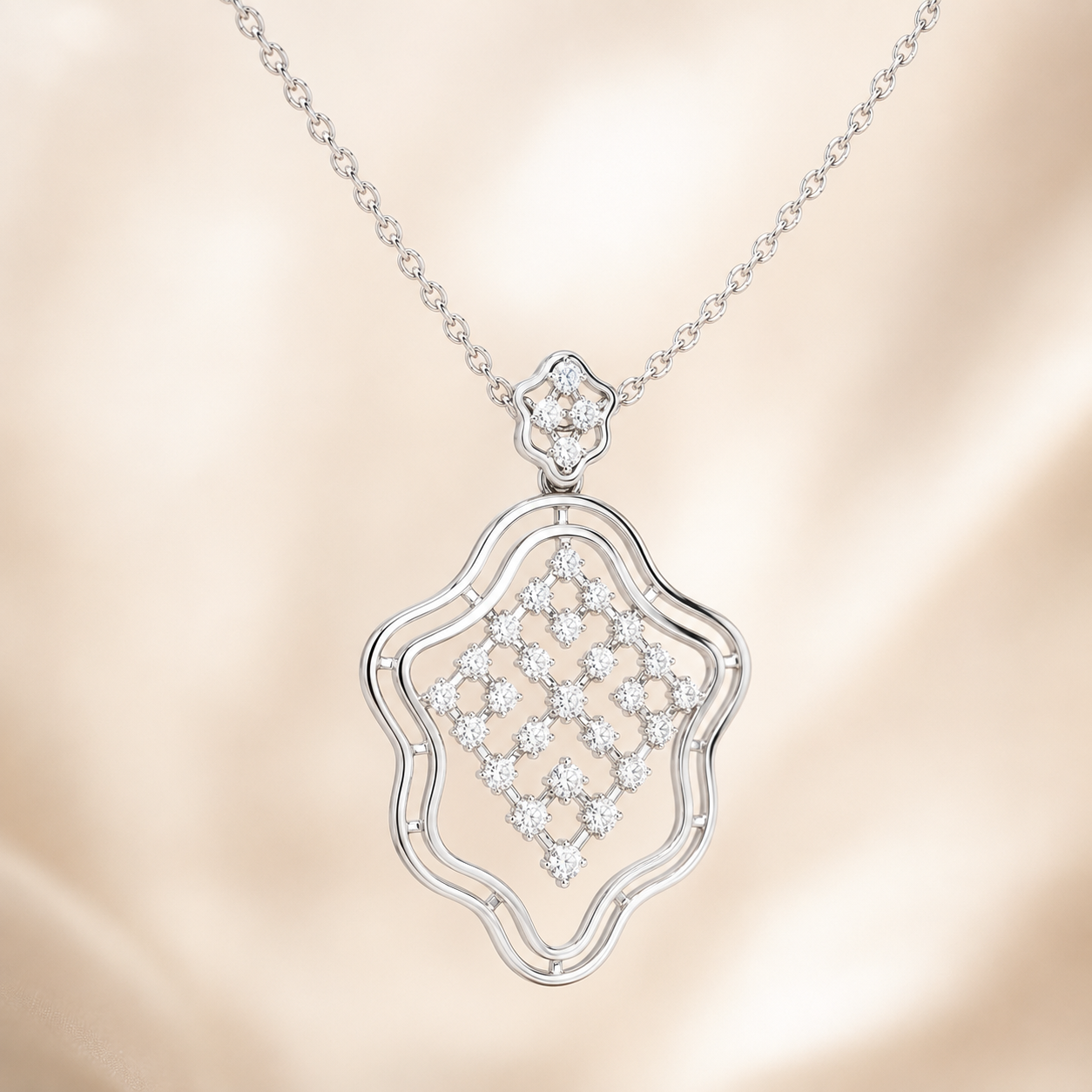 A silver-tone necklace with an openwork pendant featuring a diamond-like floral pattern, displayed against a soft beige satin background.