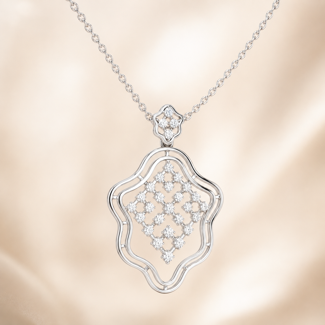 A silver-tone necklace with an openwork pendant featuring a diamond-like floral pattern, displayed against a soft beige satin background.