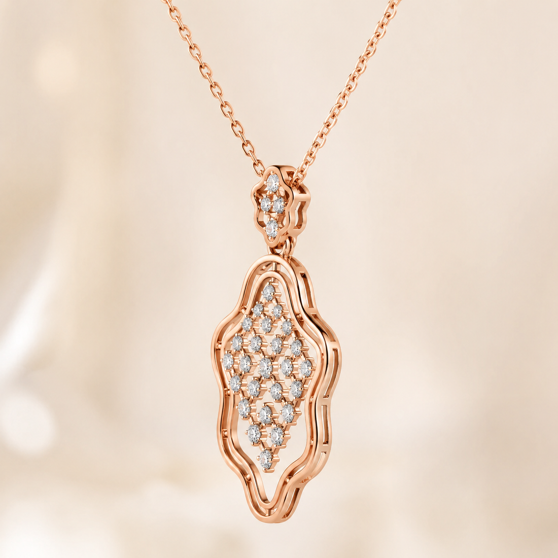 Rose gold pendant necklace with a pavé diamond design, shown on a delicate chain against a soft, warm beige background.