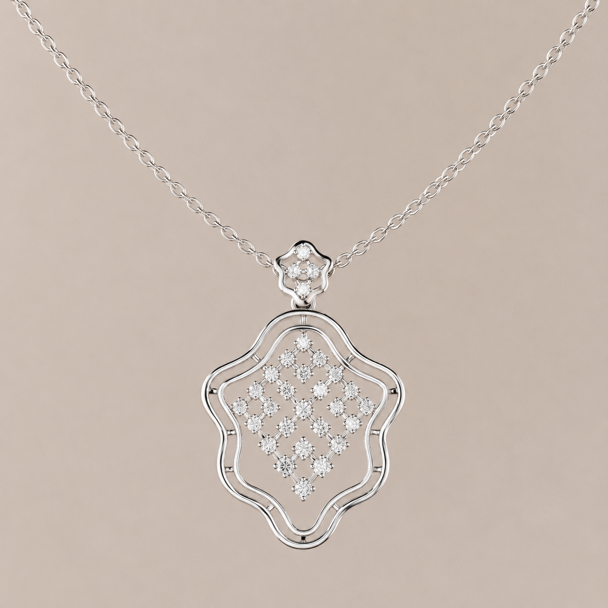 A silver pendant necklace featuring a decorative shield-shaped pendant with a pavé diamond center and a small diamond cluster at the top, suspended from a delicate link chain against a solid beige background.