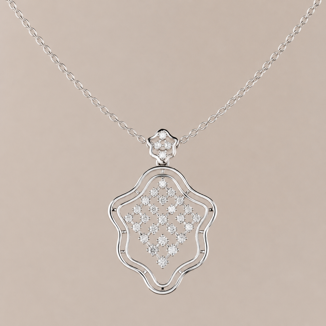 A silver pendant necklace featuring a decorative shield-shaped pendant with a pavé diamond center and a small diamond cluster at the top, suspended from a delicate link chain against a solid beige background.
