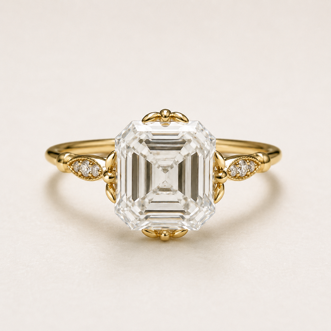 A yellow gold ring featuring a large emerald-cut clear center stone and small accent diamonds on the band, photographed on a clean off-white background.