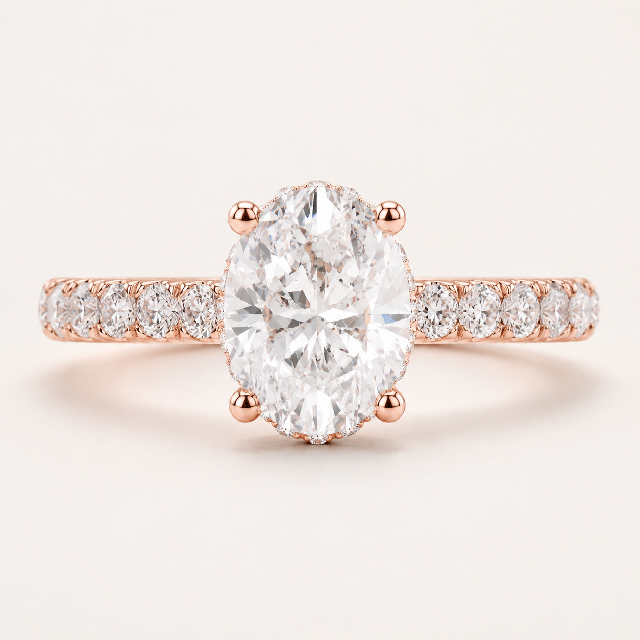 Rose gold engagement ring featuring a large oval-cut center diamond and a pavé diamond band, set against a clean off-white background.