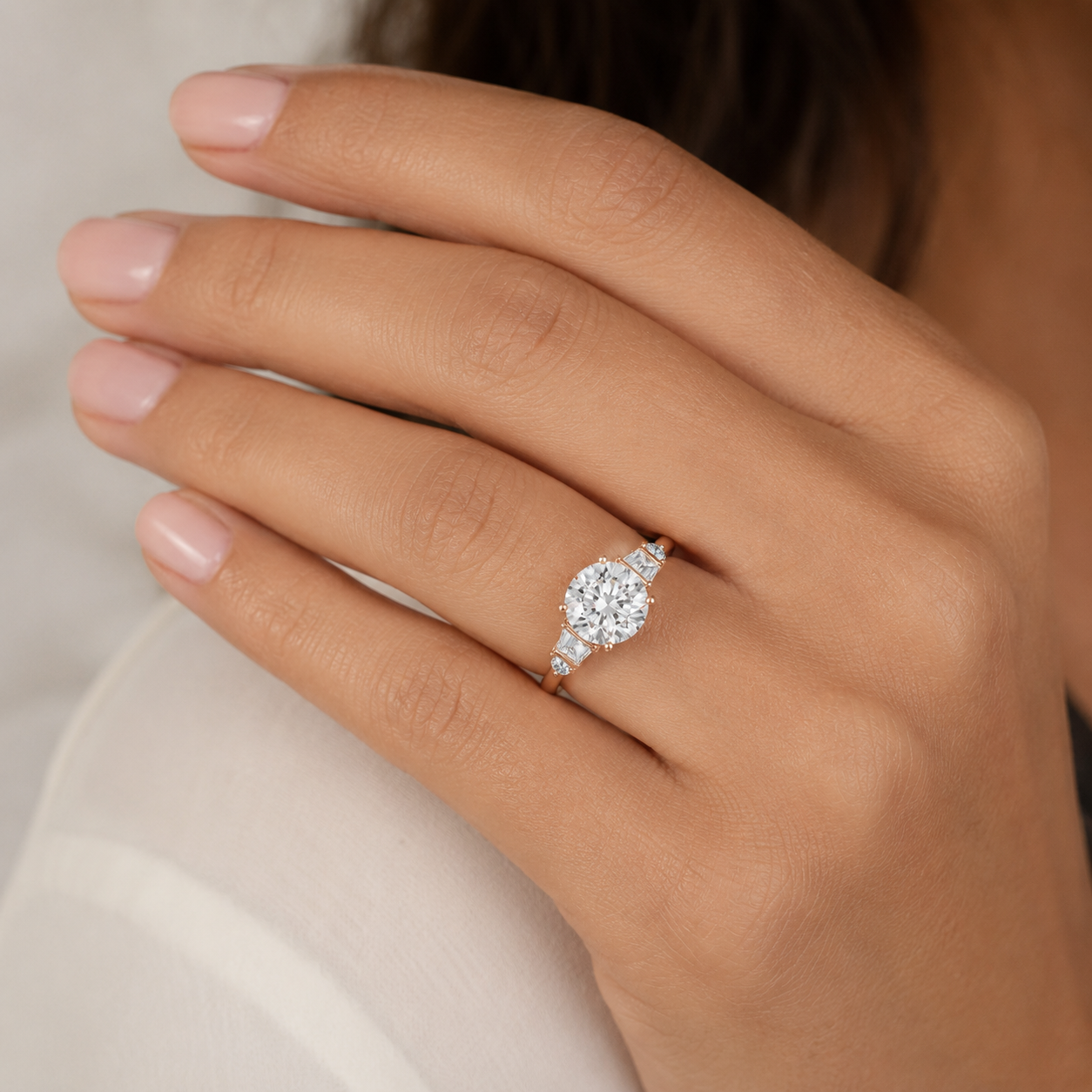 A close-up of a hand wearing a diamond engagement ring with a rose gold band.