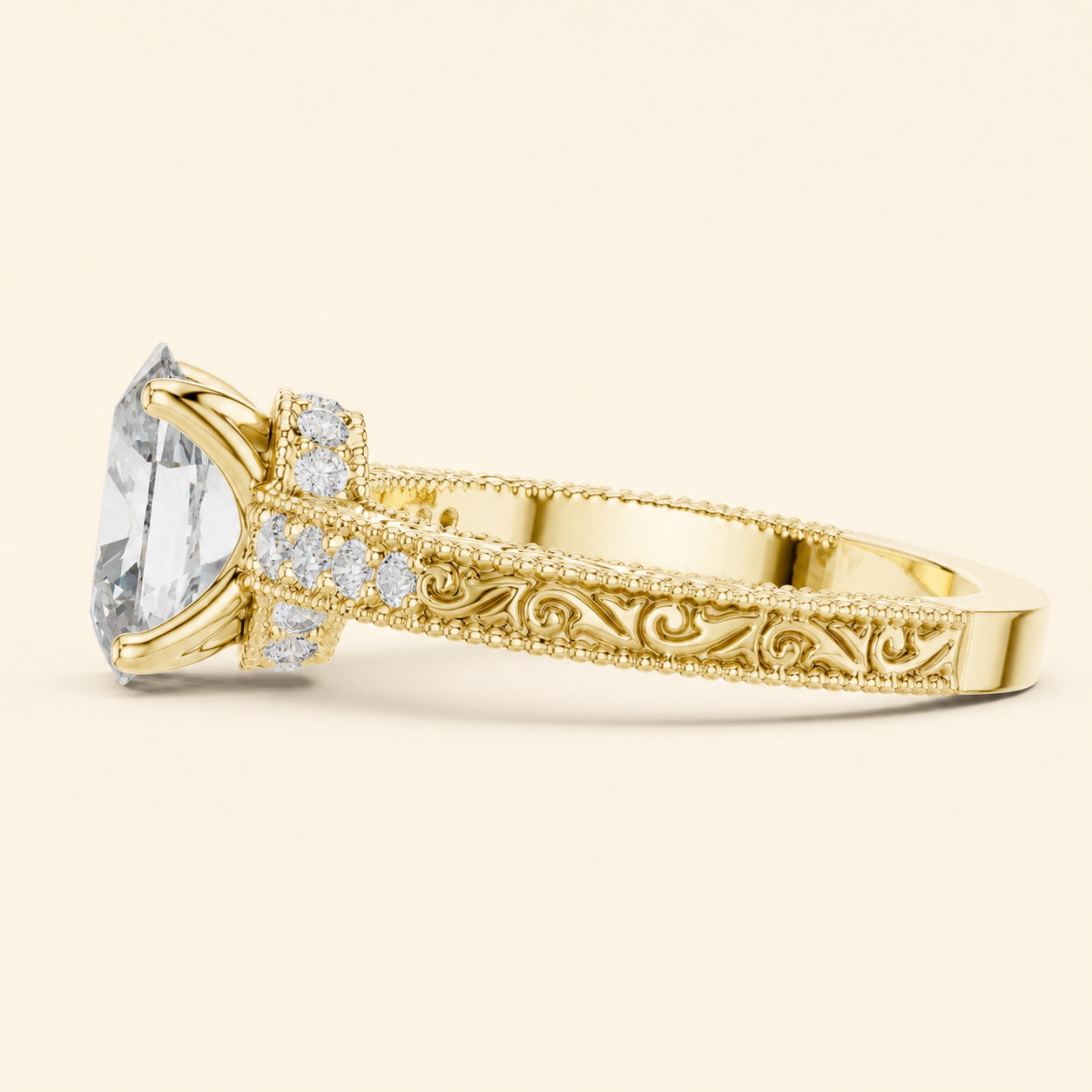 A yellow gold ring featuring a large cushion-cut clear gemstone in a prong setting, accented by small round diamonds along the band and ornate scrollwork engraving on the shank, shown against a solid cream background.