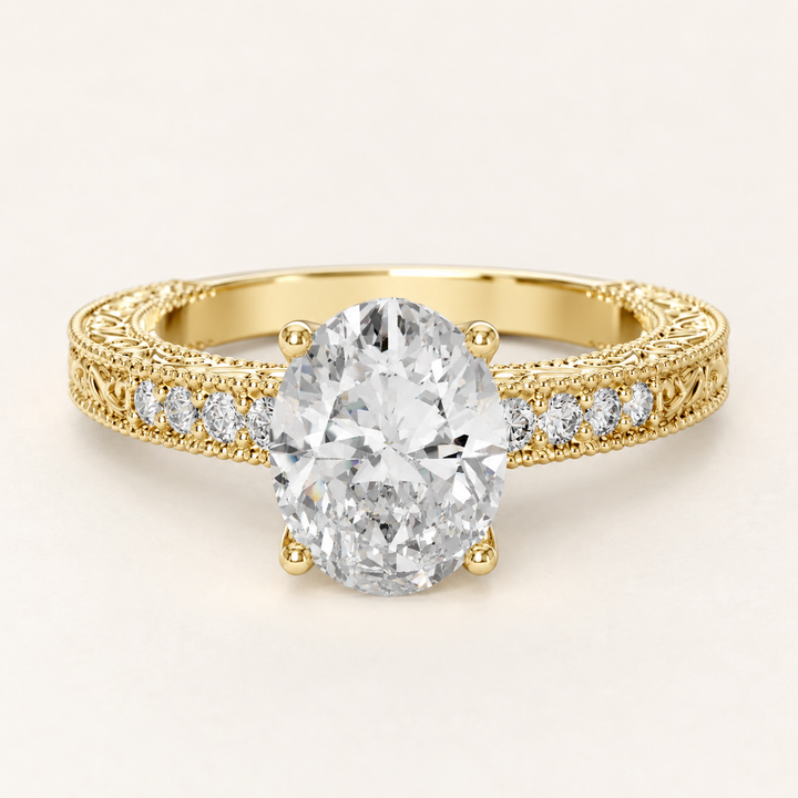 A yellow gold engagement ring featuring a large oval-cut center diamond and smaller diamonds set along the shoulders, shown on a clean off-white background.