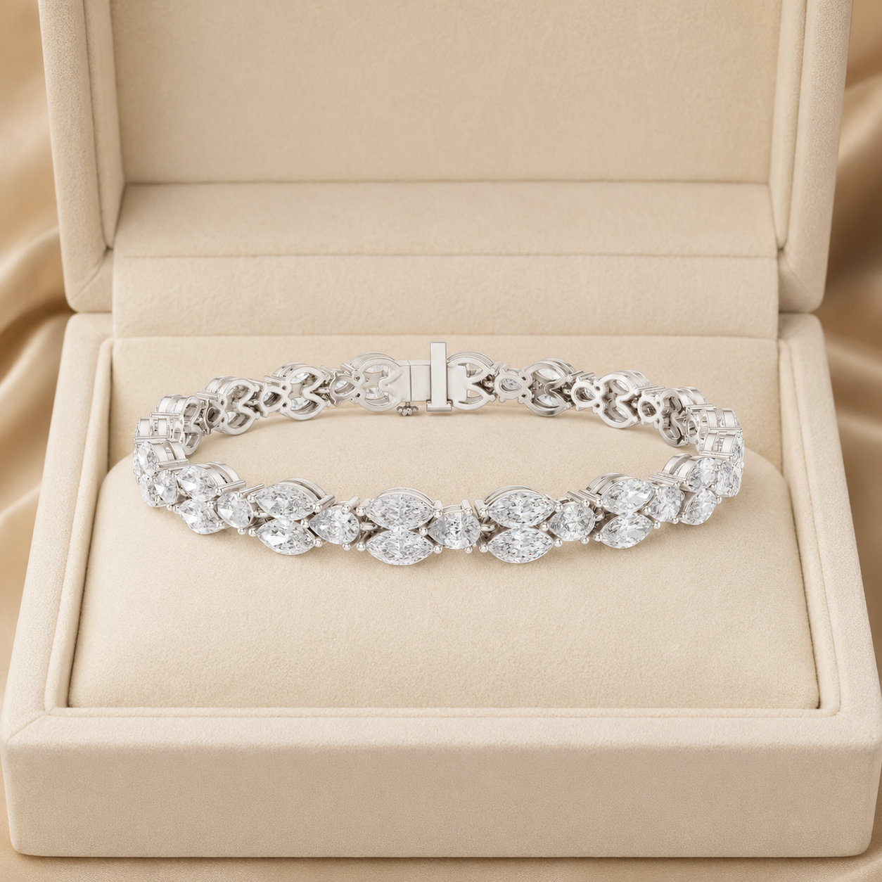A silver tennis bracelet set with round and oval-cut clear gemstones, displayed inside an open beige jewelry box on a satin fabric background.