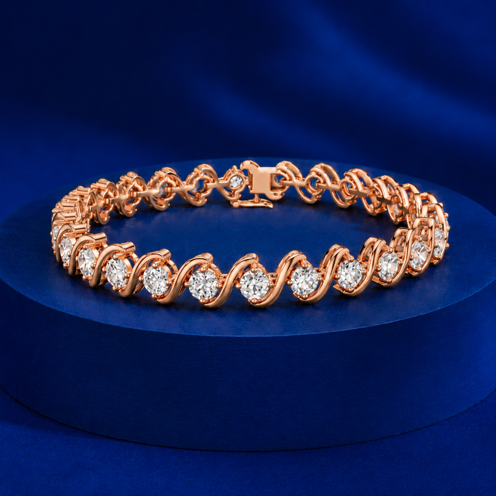 A rose gold tennis bracelet with round-cut clear stones, displayed on a dark blue circular pedestal against a matching blue background.