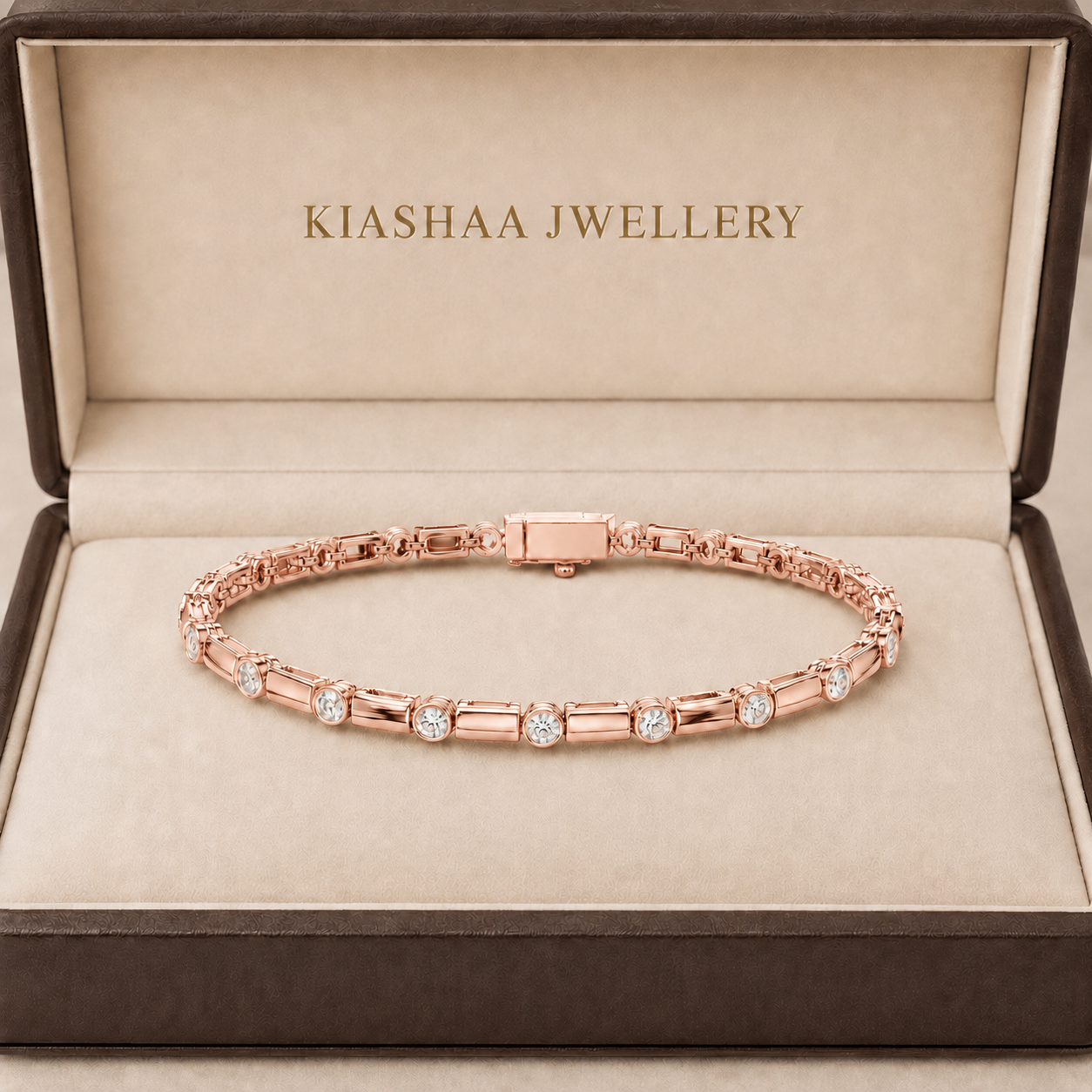 A rose gold tennis bracelet with round-cut clear stones, presented in an open brown jewelry box with 'KIASHAA JEWELLERY' printed inside.