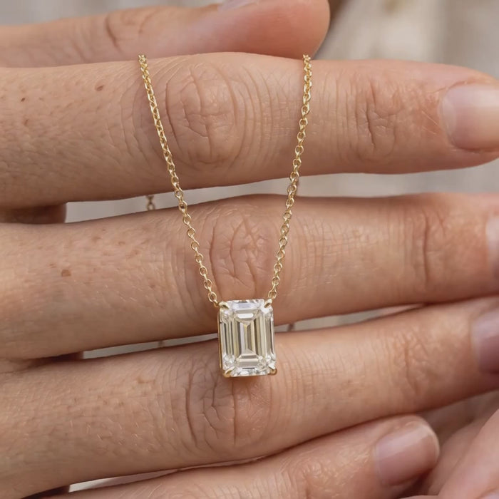 2.58 CT emerald-cut diamond solitaire pendant necklace in polished yellow gold.