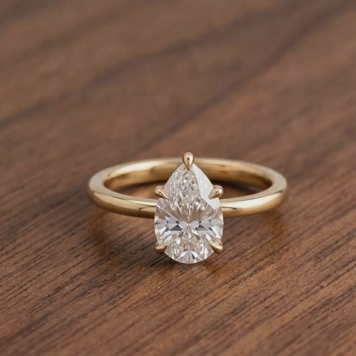 Pear-cut diamond proposal ring with slim polished gold band